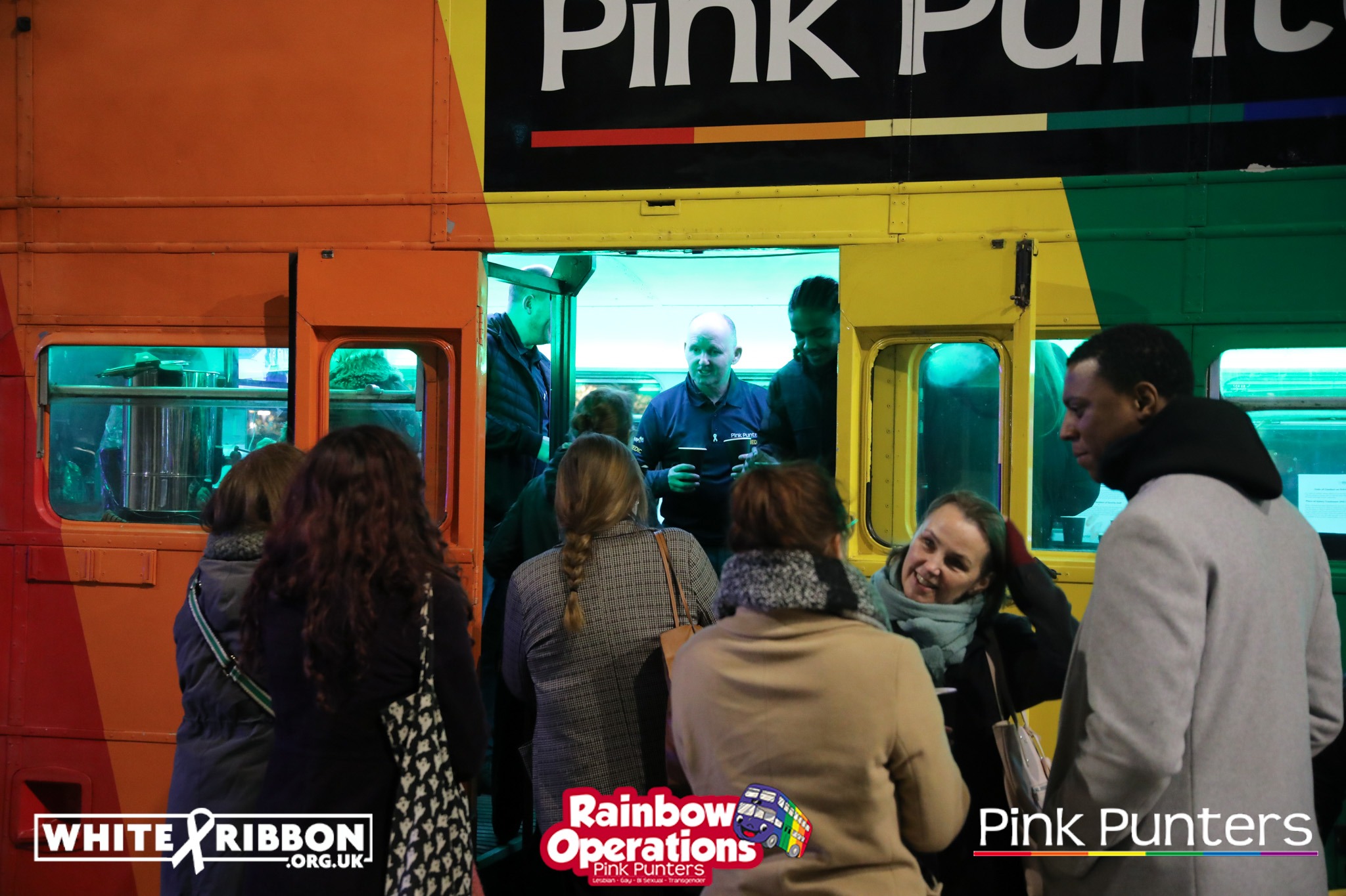 The Pink's team passing out hot drinks to attendees of the White Ribbon Vigil