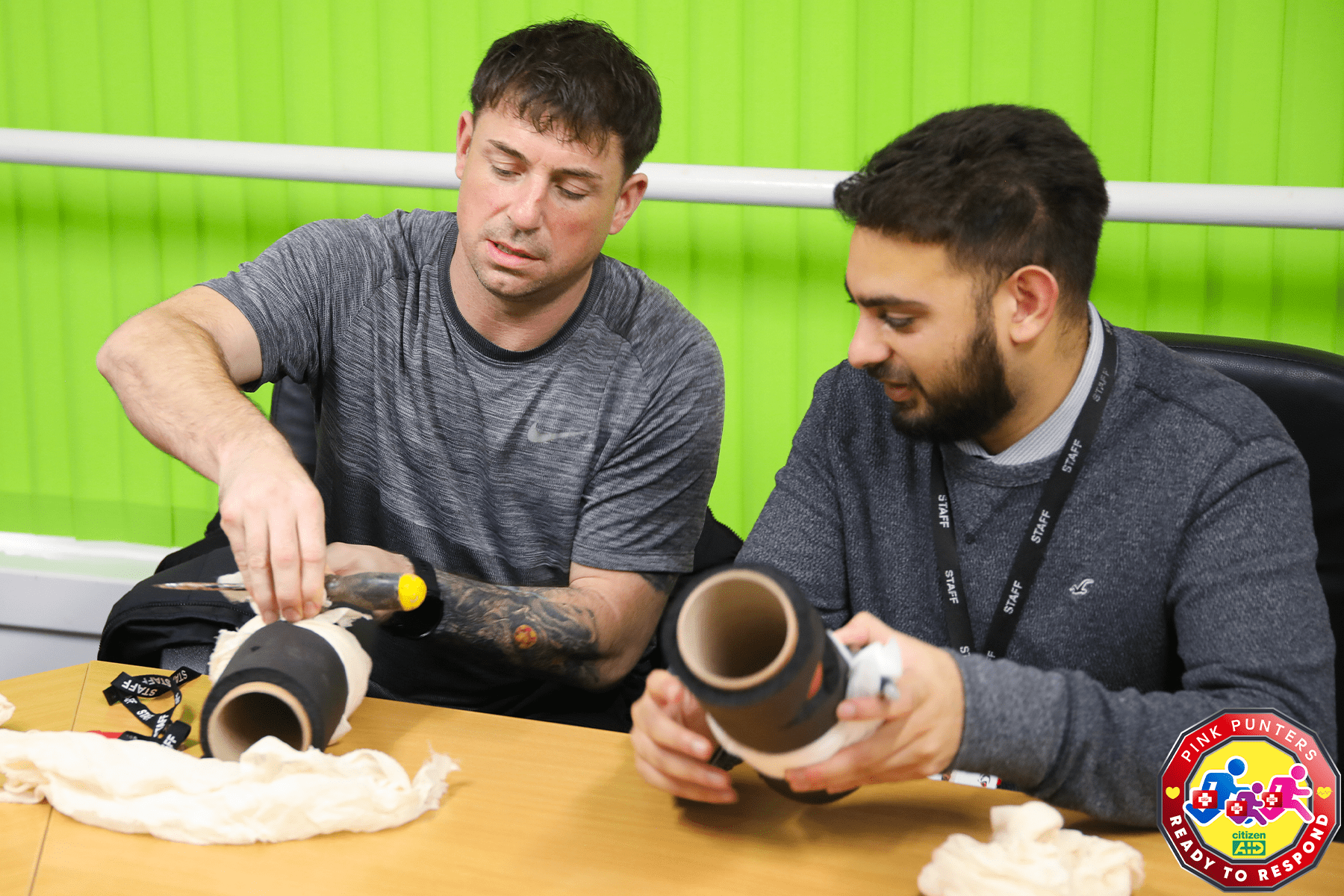 Staff members at Shenley Brook End School practicing a tourniquet with household items_